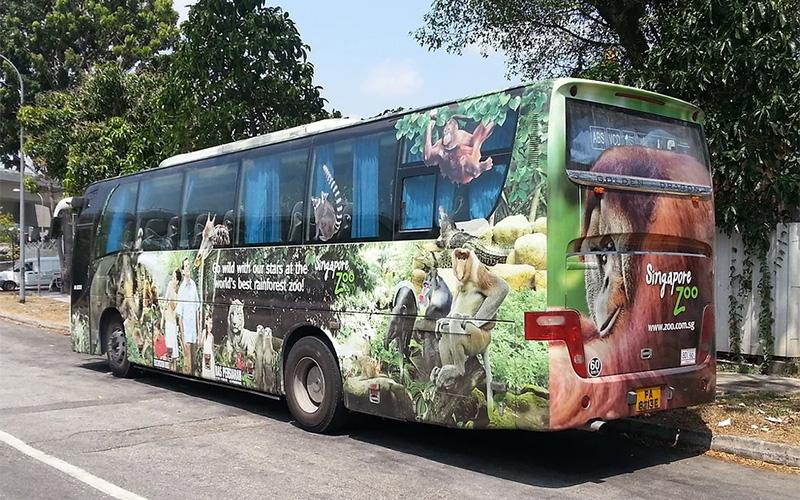 Fully wrapped event transport bus parked on the street